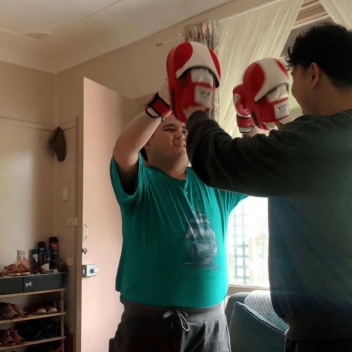 An in-home boxing session adapted to a participant's preferred pace