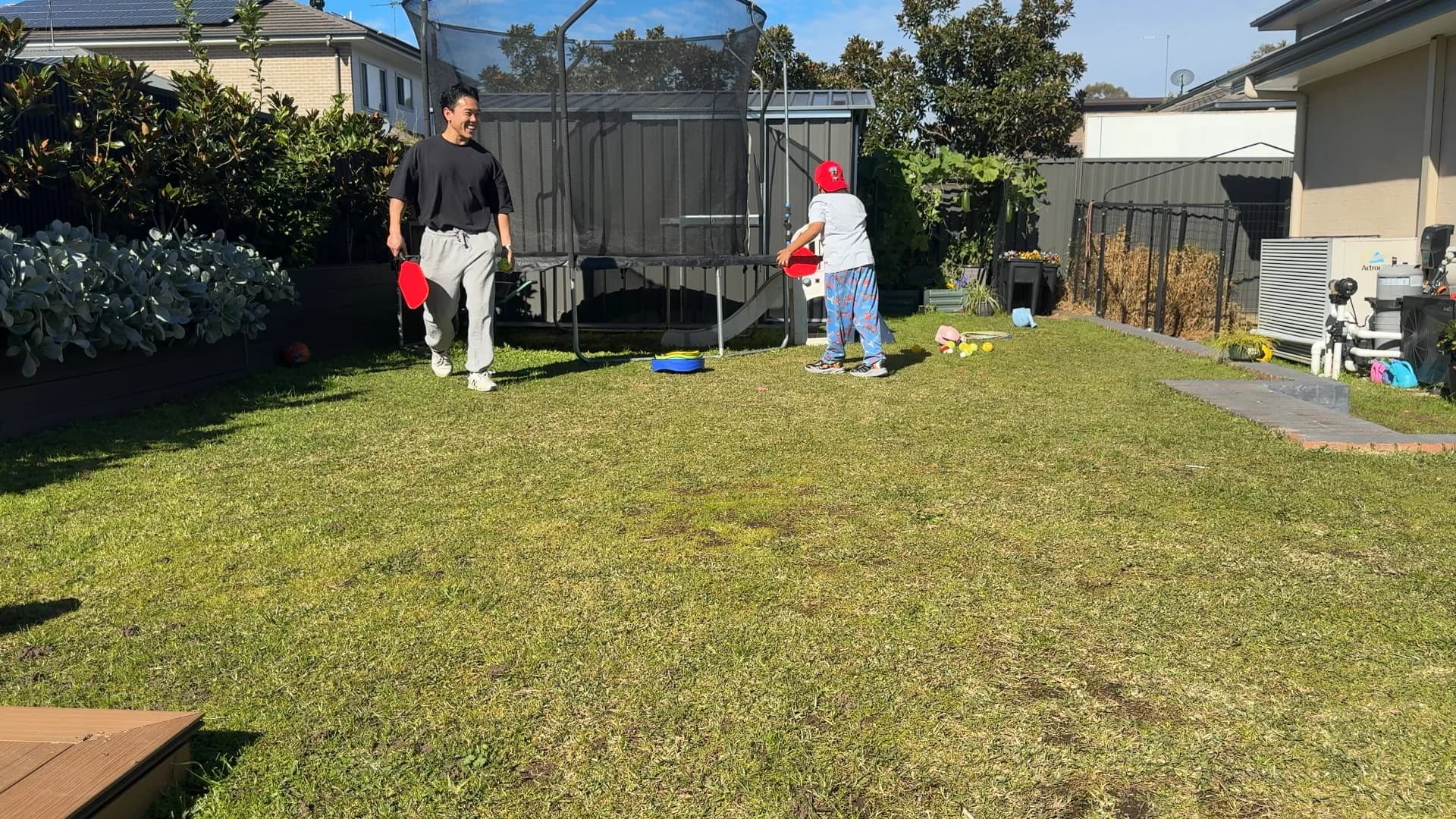 A child and therapist playing padel together
