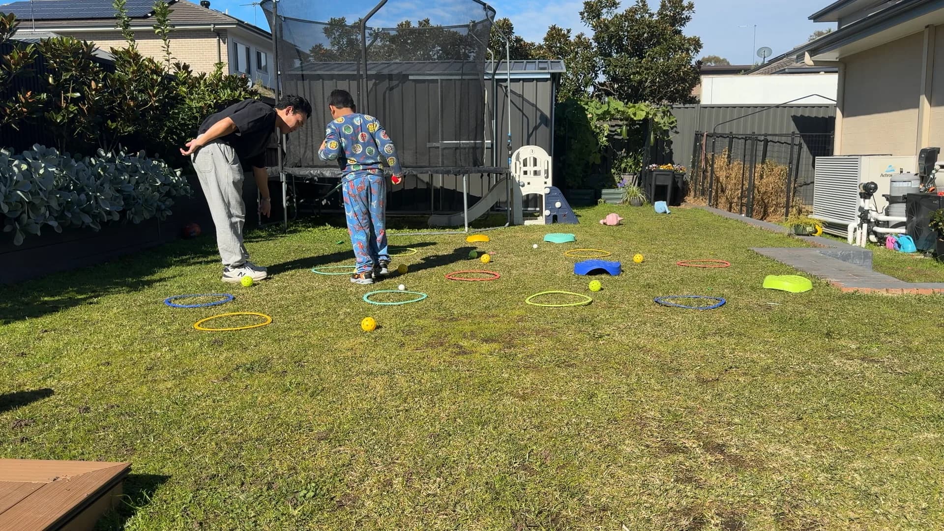 A child playing a movement game with a therapist