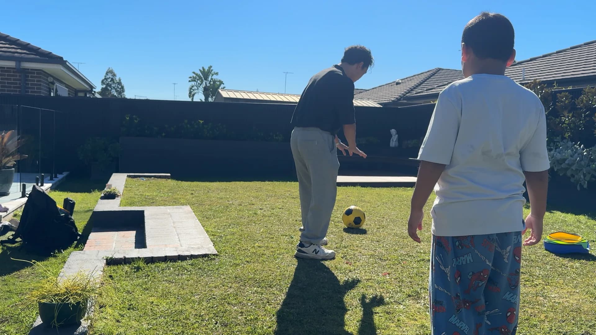 A therapist demonstrating a soccer skill to a child