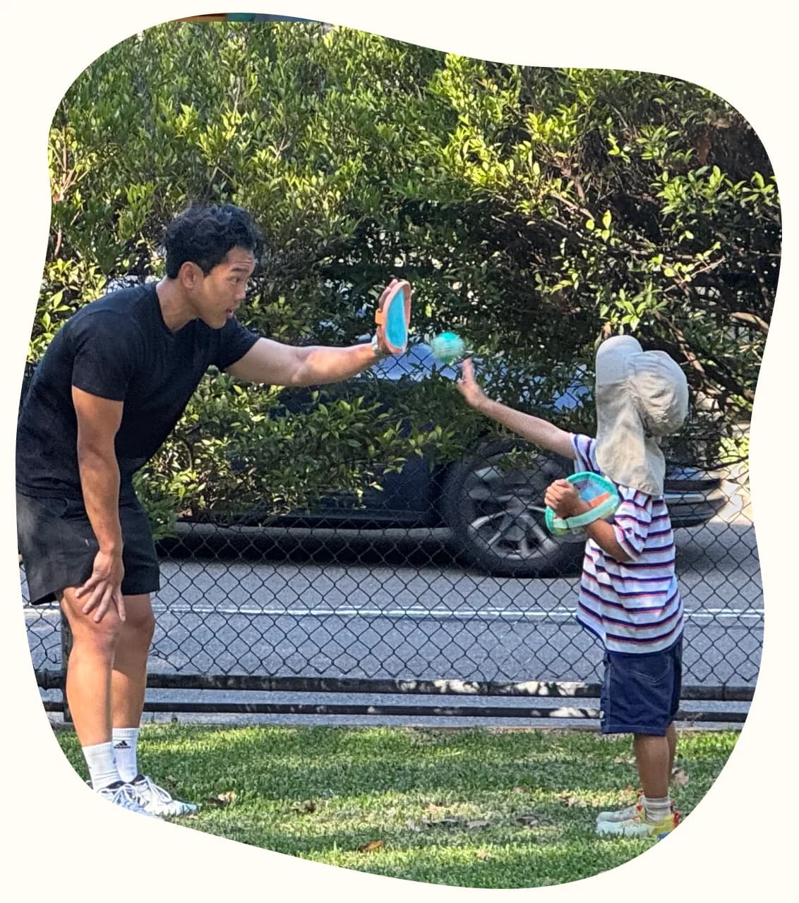 A Drift Health clinician and a child playing a catching game on the grass
