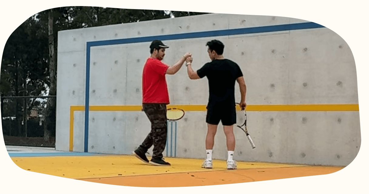 A participant and clinician high-fiving after an outdoor session