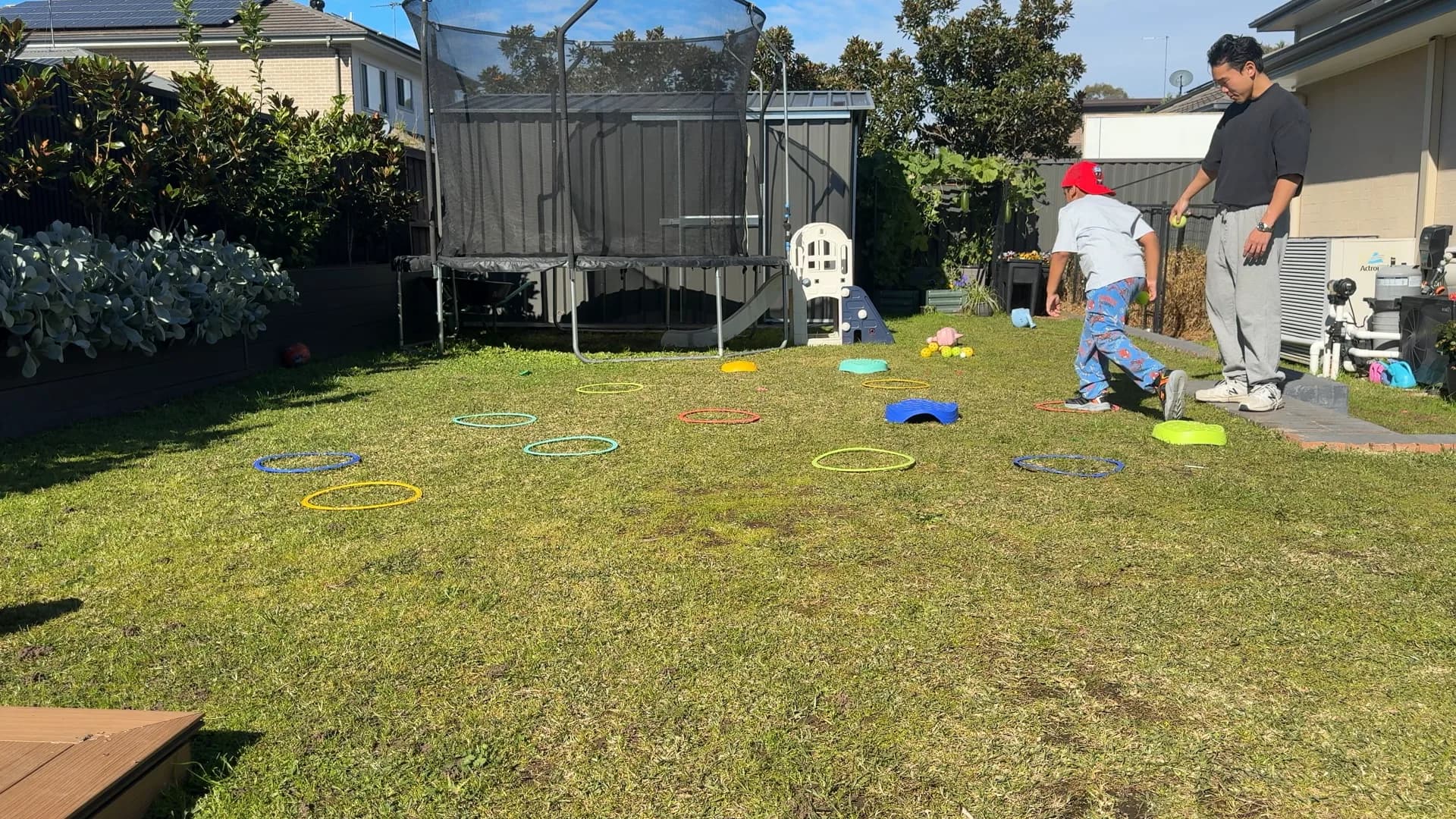 A child stepping through hoops during a movement game