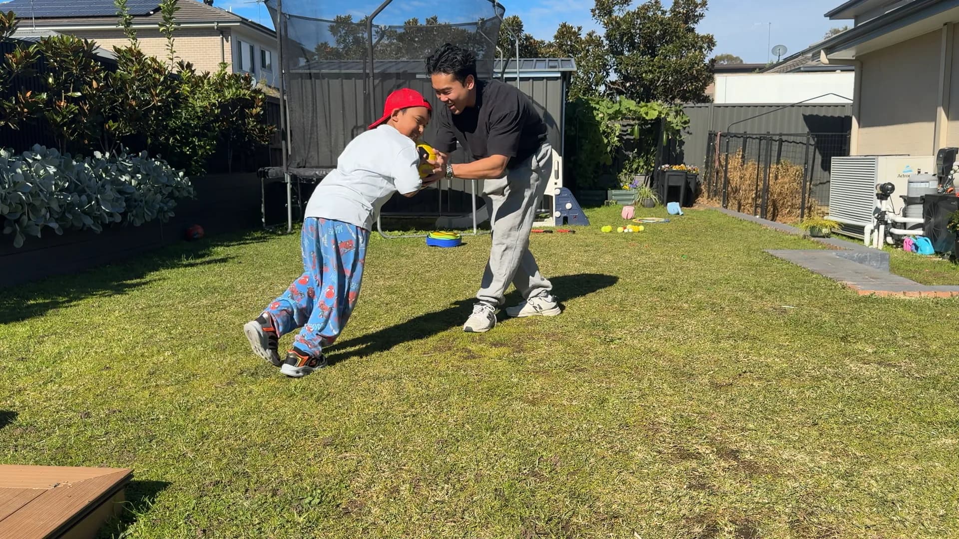 A child and therapist laughing during a playful movement game