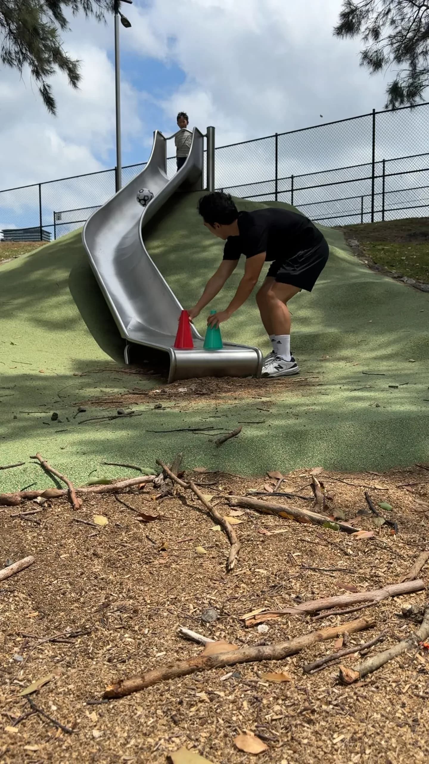 A child playing with cones at a playground
