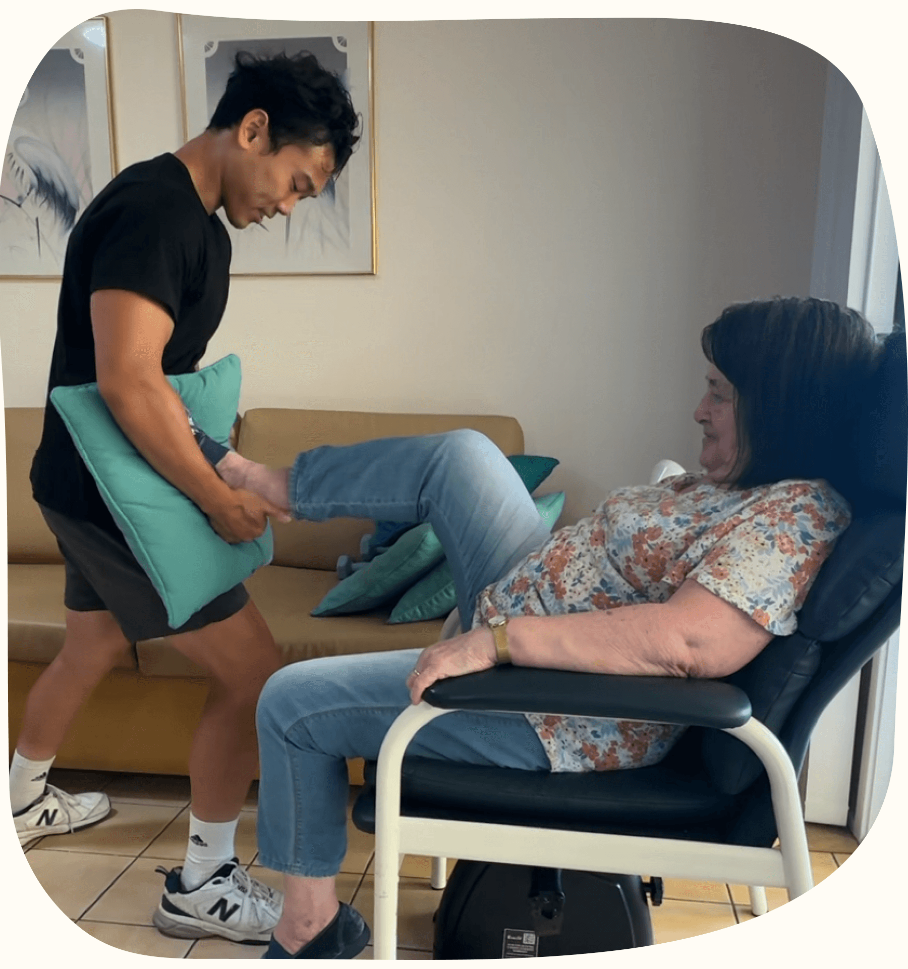 A senior completing exercise therapy at home with support