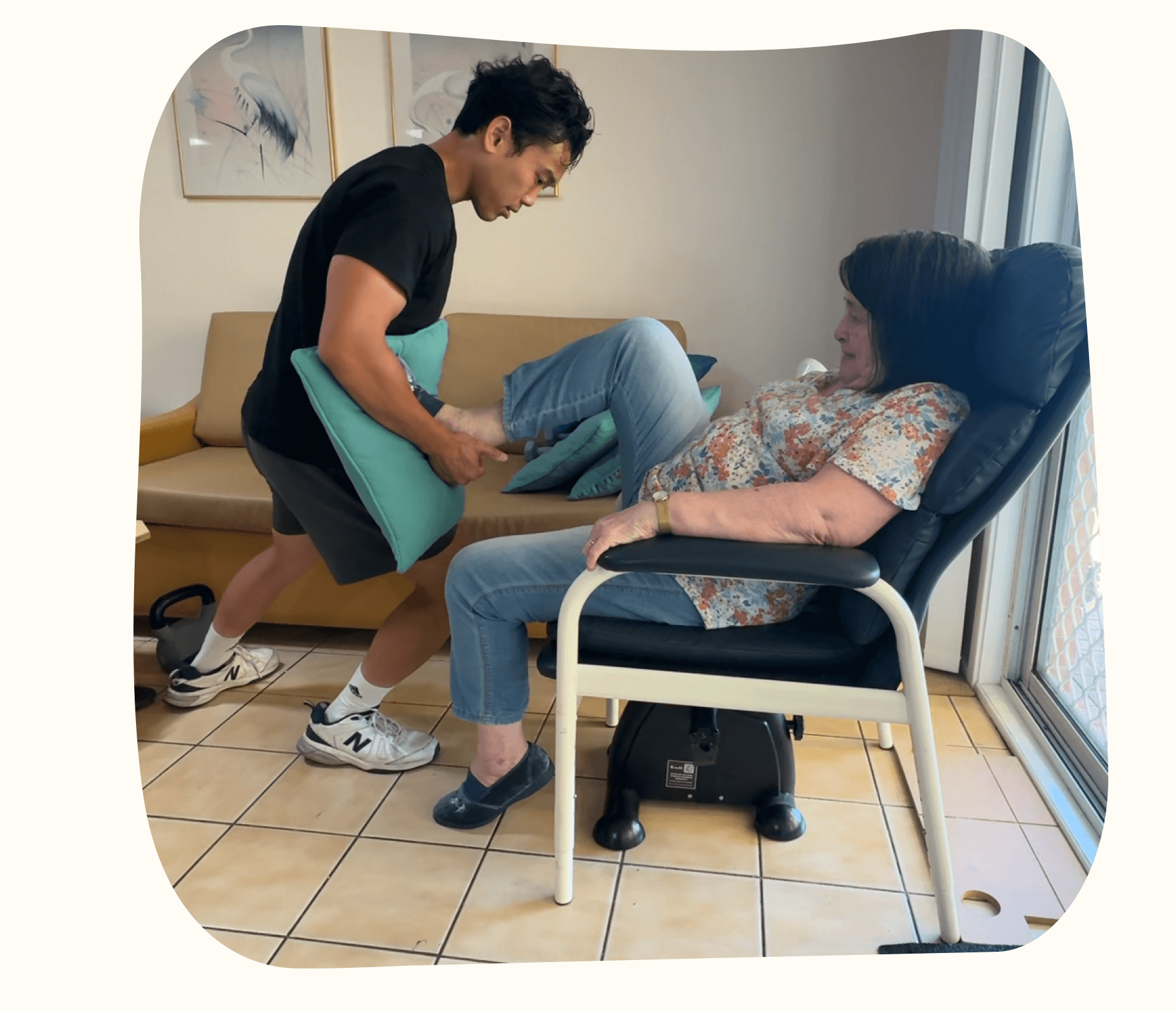 A physiotherapist supporting a senior's movement